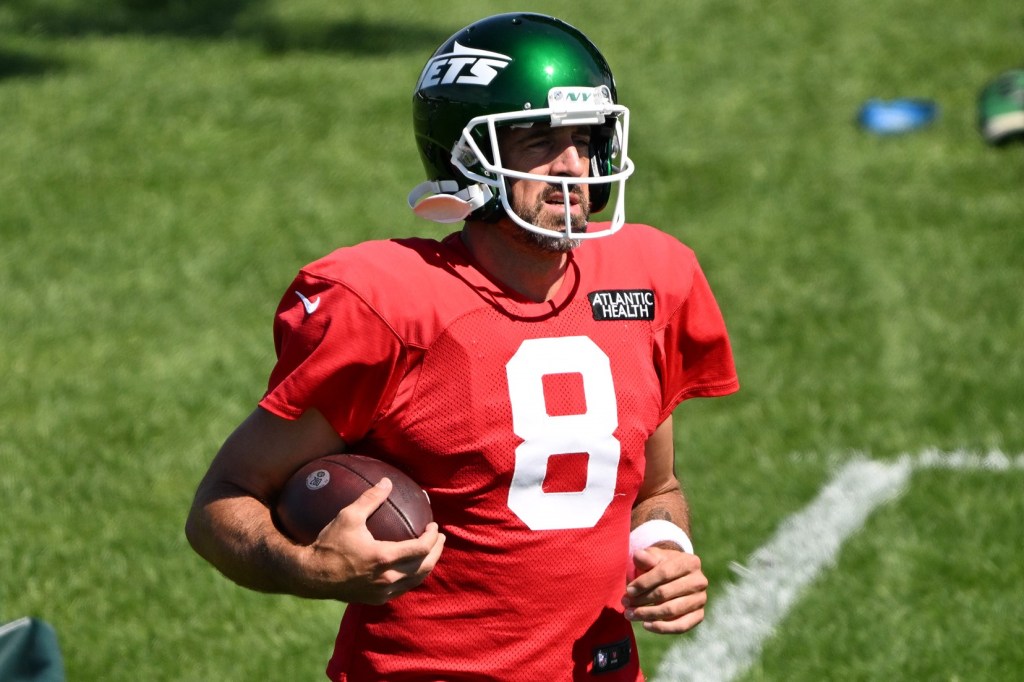 Aaron Rodgers runs during the Jets' training camp practice on Aug. 13, 2024.