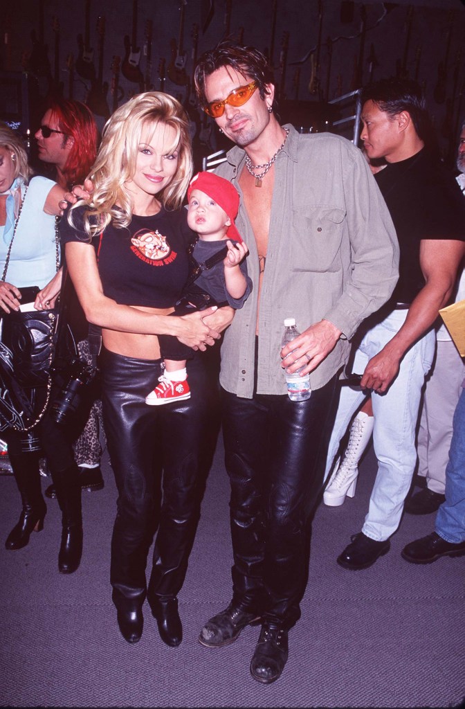 Brandon Lee, Tommy Lee and Pamela Anderson putting their hands in cement at the RockWalk event at Guitar Center in Hollywood, California.