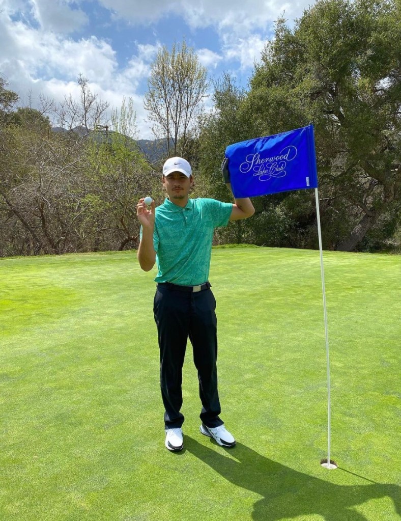 Brandon Thomas Lee holds up a golf ball at the Sherwood Country Club.