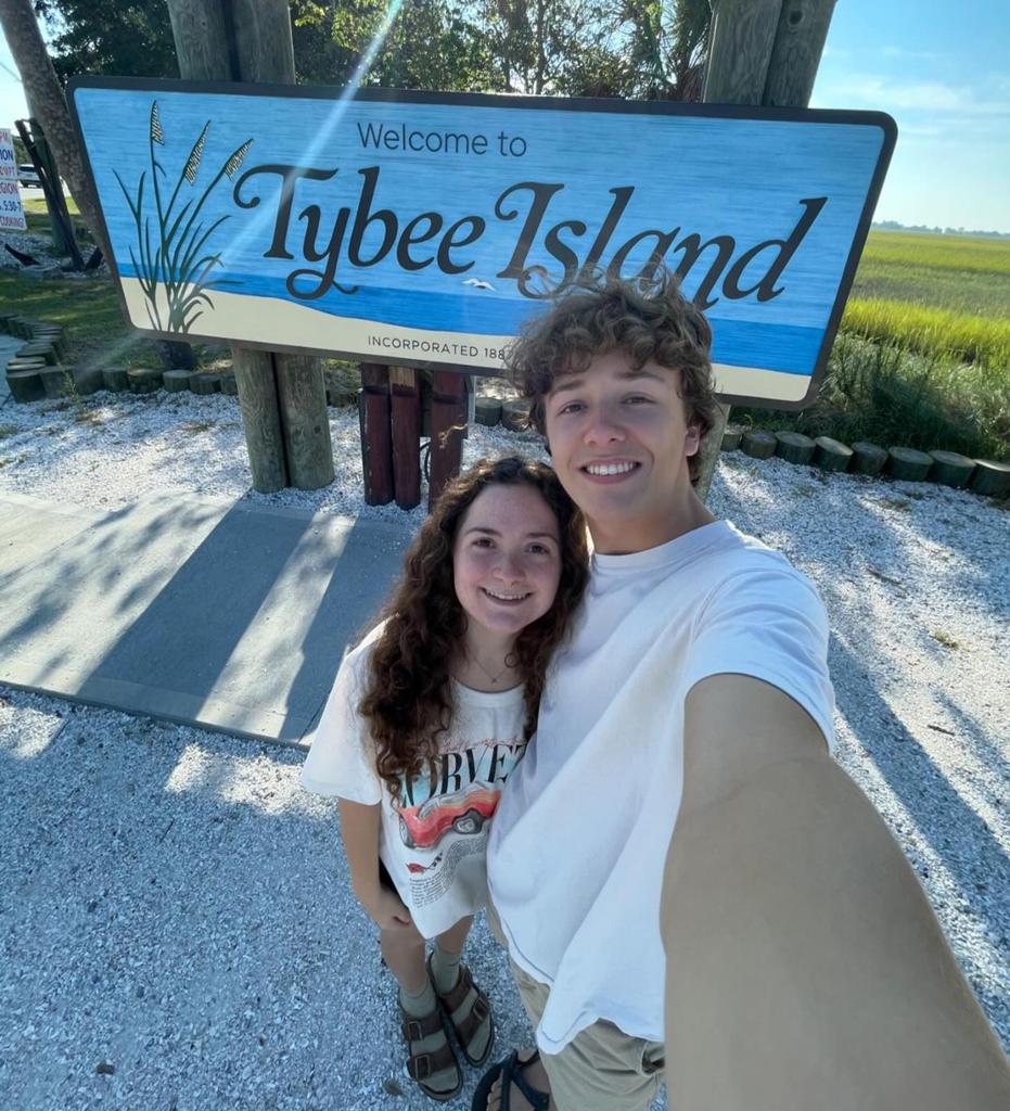 Autumn posing for a selfie with her boyfriend, Tyler, in front of a sign for Tybee Island in Georgia. 