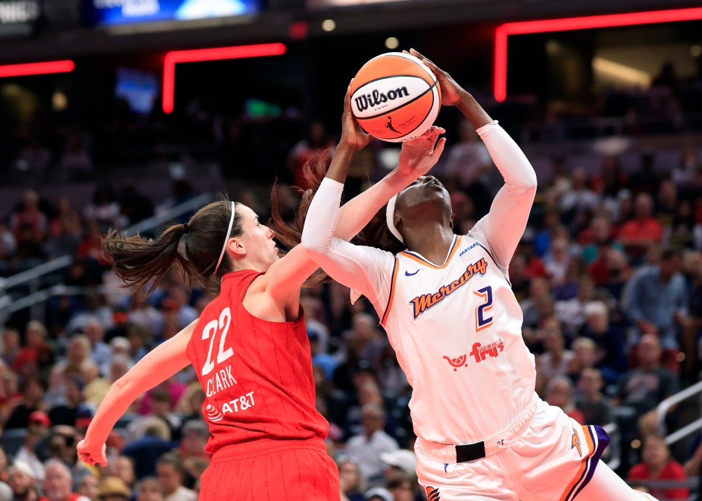 Caitlin Clark #22 of the Indiana Fever fouls Kahleah Copper #2 of the Phoenix Mercury during the first half at Gainbridge Fieldhouse on August 16, 2024.