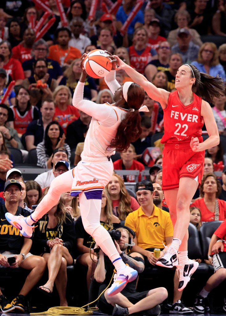 Caitlin Clark #22 of the Indiana Fever blocks the shot of Kahleah Copper #2 of the Phoenix Mercury during the second half at Gainbridge Fieldhouse on August 16, 2024.