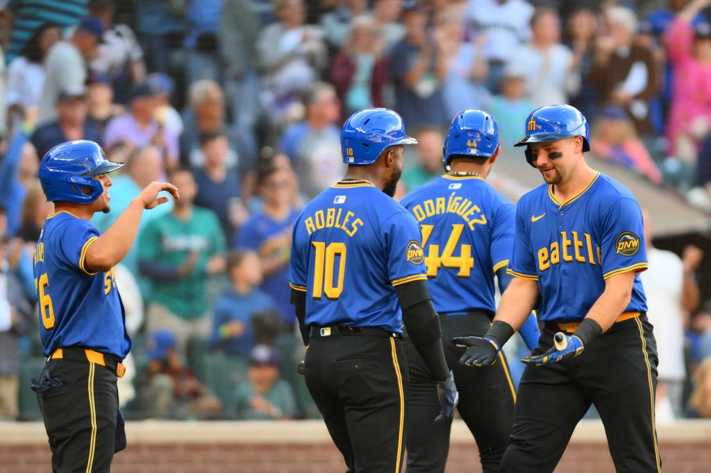 Seattle Mariners catcher Cal Raleigh (29) celebrates with center fielder Victor Robles (10) after hitting a 2-run home run against the New York Mets during the sixth inning at T-Mobile Park on Aug. 11, 2024.