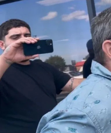 A photo of a predator catcher filming an alleged pedophile.