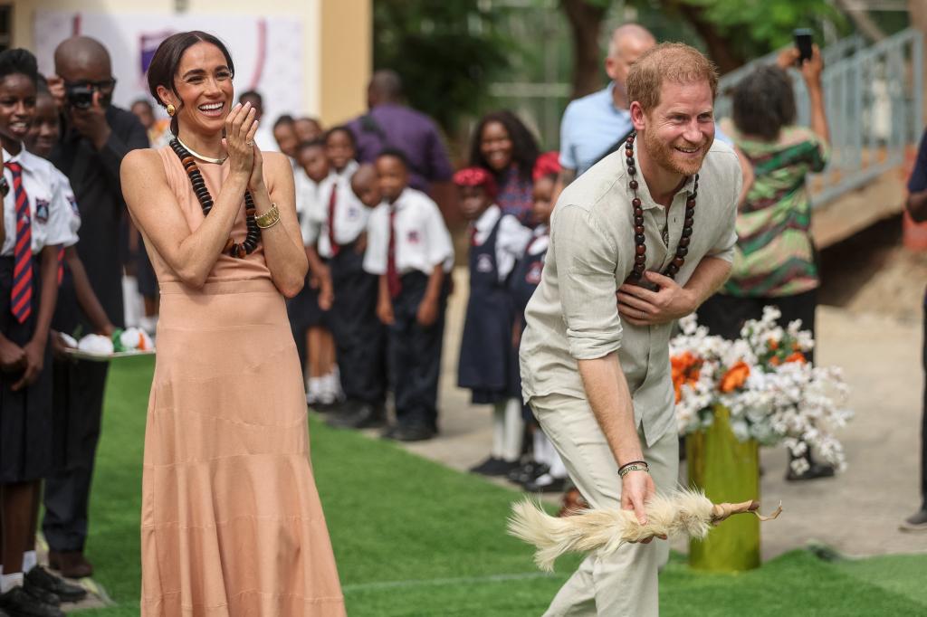 Britain's Prince Harry (R), Duke of Sussex, and Britain's Meghan (L), Duchess of Sussex, take part in activities as they arrive at the Lightway Academy in Abuja on May 10, 2024 as they visit Nigeria as part of celebrations of Invictus Games anniversary. 