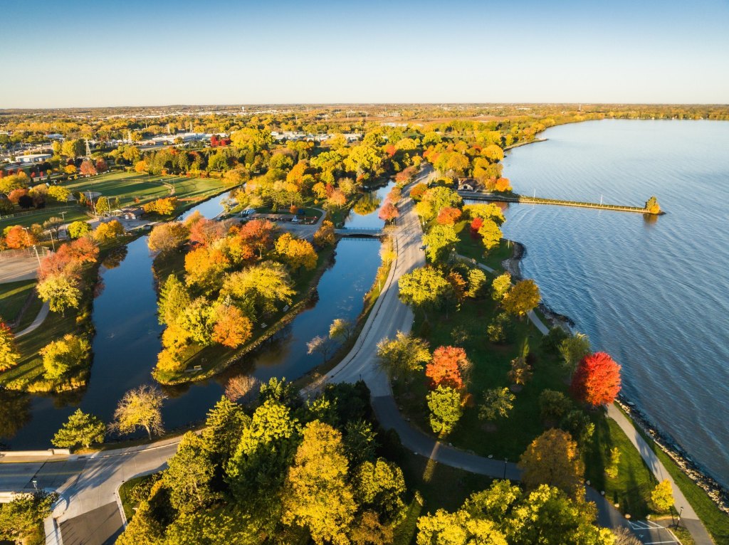 A road surrounded by trees leading towards Fond du Lac and Lake Winnebago in Wisconsin