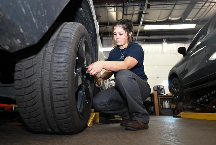 Emiley Filuta working on a tire