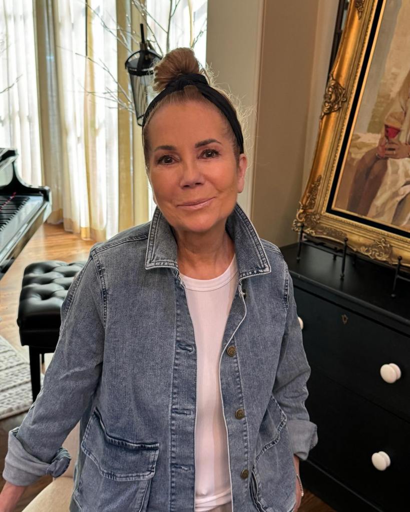 Kathie Lee Gifford keeps it casual in a denim jacket and wears her hair in a high bun while smiling at the camera.