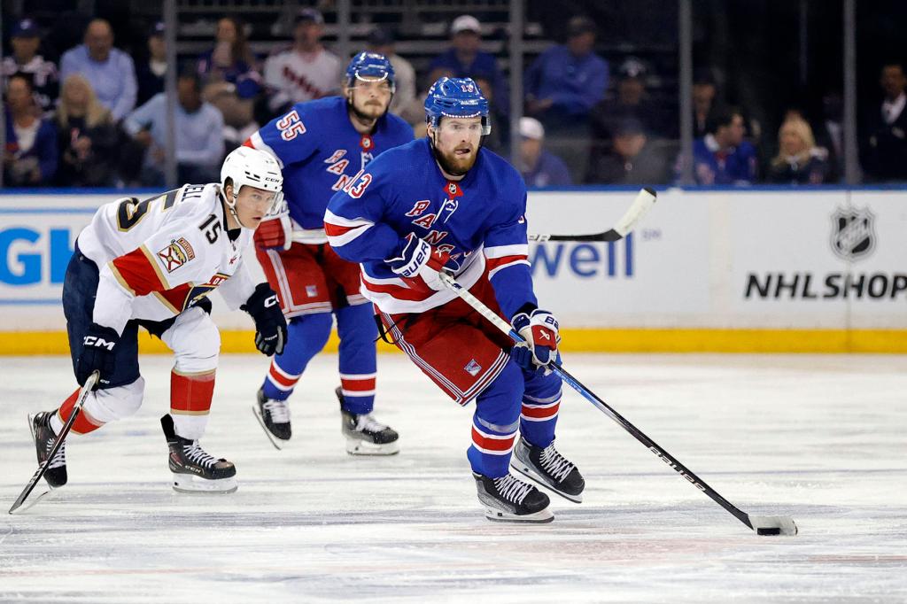 New York Rangers left wing Alexis Lafreniere (C) skates away with the puck while Florida Panthers center Anton Lundell trails behind in the third period at Madison Square Garden in New York, New York, USA, May 30, 2024. 