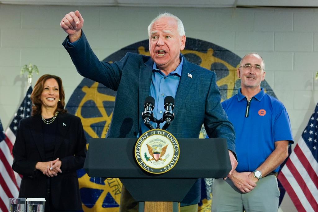 Tim Walz speaking at a lectern with Kamala Harris to his side