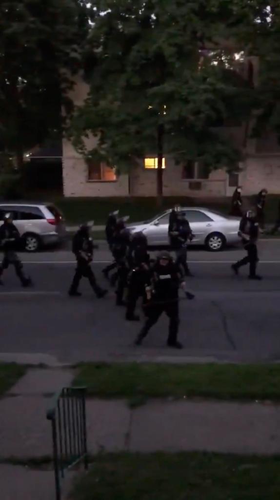 Police gathered on a suburban street, iphone video.