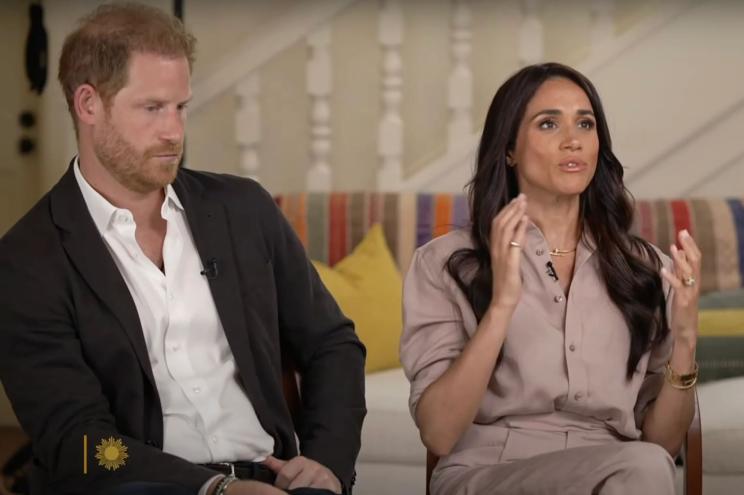 Prince Harry and Meghan Markle sitting in chairs, discussing Meghan's mental health struggles during her time in the palace