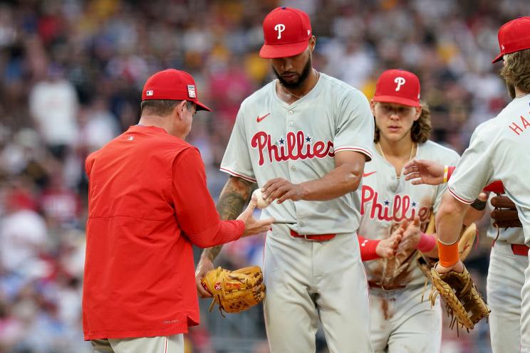 Philadelphia Phillies starting pitcher Cristopher Sanchez, center, hands the ball to manager Rob Thomson, left, during the sixth inning of a baseball game against the Pittsburgh Pirates Saturday, July 20, 2024, in Pittsburgh.