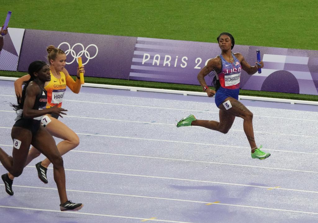 Sha'carri Richardson (USA) looks towards Daryll Neita (GBR) in the women's 4x100m relay final during the Paris 2024 Olympic Summer Games at Stade de France.