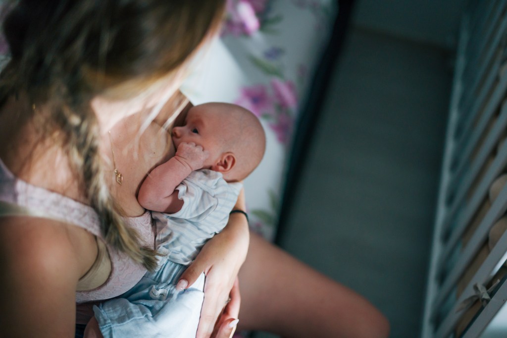 Young mother breastfeeding her newborn baby