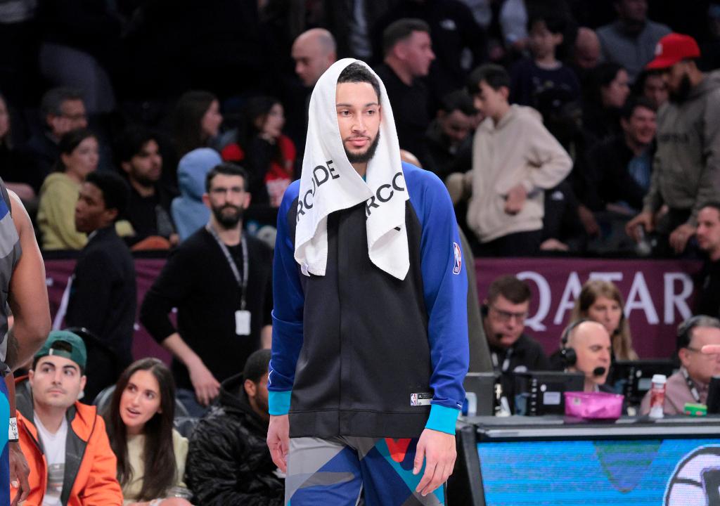 Ben Simmons #10 of the Brooklyn Nets with a towel on his head as he stands on the sideline during the second quarter.