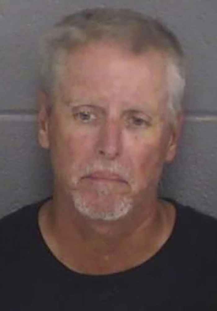 Mugshot of Colin Gray, a man with white hair and beard, charged with crimes related to the Georgia High School shooting incident.