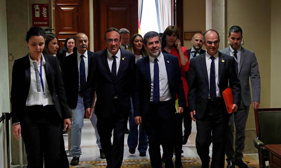 Josep Rull, Jordi Sánchez e Jordi Turull deixam sede do Parlamento espanhol, em Madri; separatistas catalães voltariam à prisão após terem tomado posse dos cargos para os quais foram eleitos Foto: Susana Vera / REUTERS