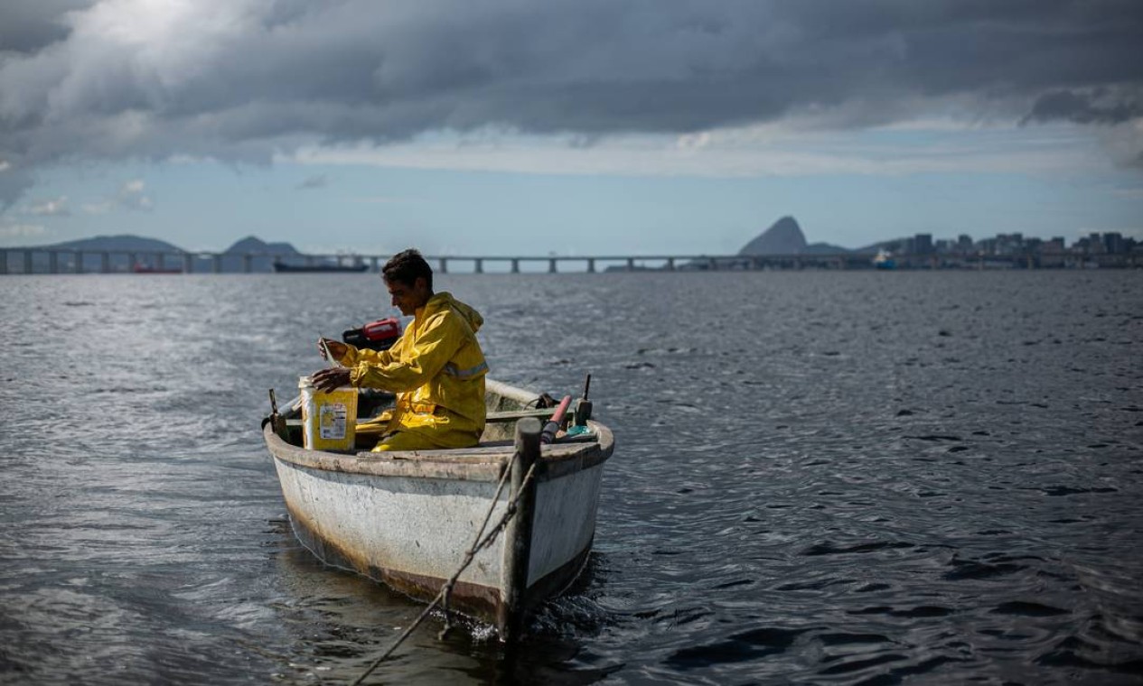 Um século de histórias de pescador. A poluição da Baía de Guanabara e a concorrência dos grandes barcos reduzem a produção de pescado a cada dia para quem vive da pesca artesanal, como André Monteiro, há 35 anos no mar, no trecho onde deságua o Rio Jequiá, que significa cesto cheio de peixes na língua tupi. A primeira colônia de pesca fundada no país, a Z10, na Ilha do Governador, completou cem anos em novembro. Foto: Hermes de Paula / Agência O Globo - 22/10/2020