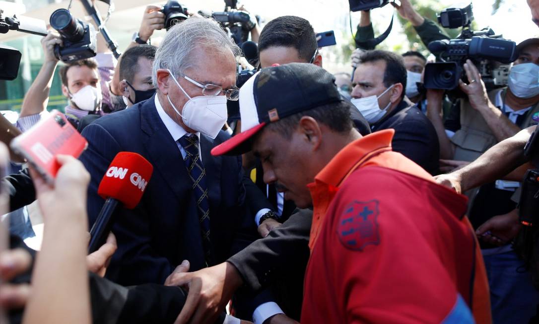 Ministro Paulo Guedes dá dinheiro a desempregado na Esplanada dos Ministérios, em Brasília Foto: ADRIANO MACHADO / REUTERS