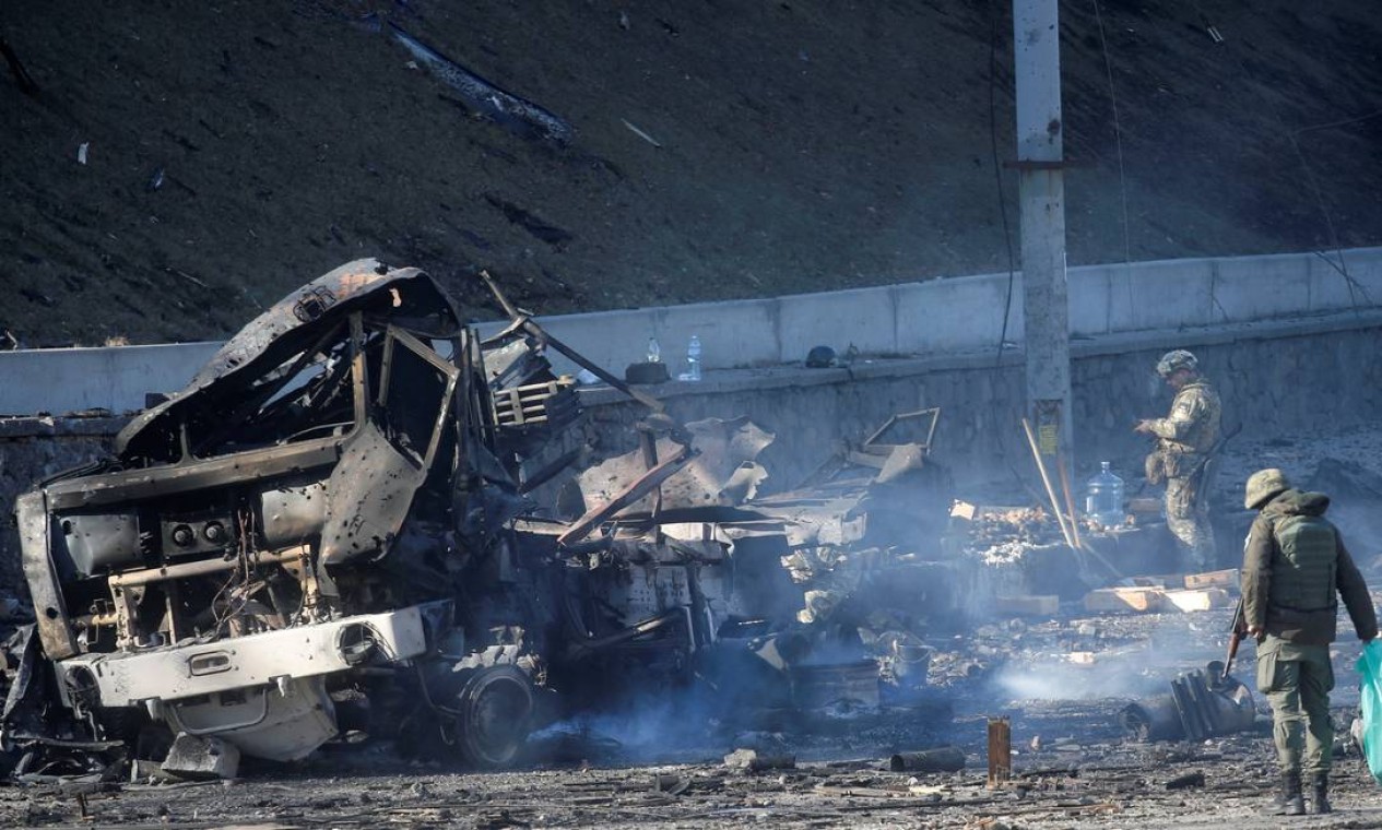 Militares ucranianos inspecionam um veículo danificado, no local de combate com tropas russas em Kiev Foto: VALENTYN OGIRENKO / REUTERS