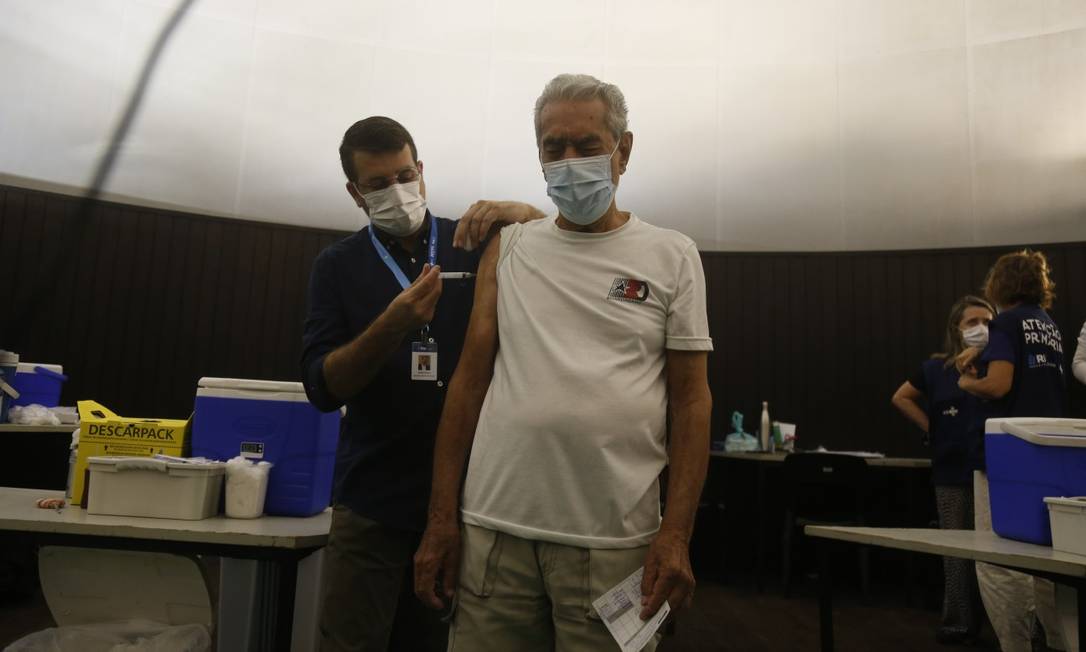 O secretário municipal de Saúde, Daniel Soranz, aplica a quarta dose contra a Covid-19 em Aroldo Corrêa da Silva, 85 anos Foto: Fabiano Rocha / Fabiano Rocha