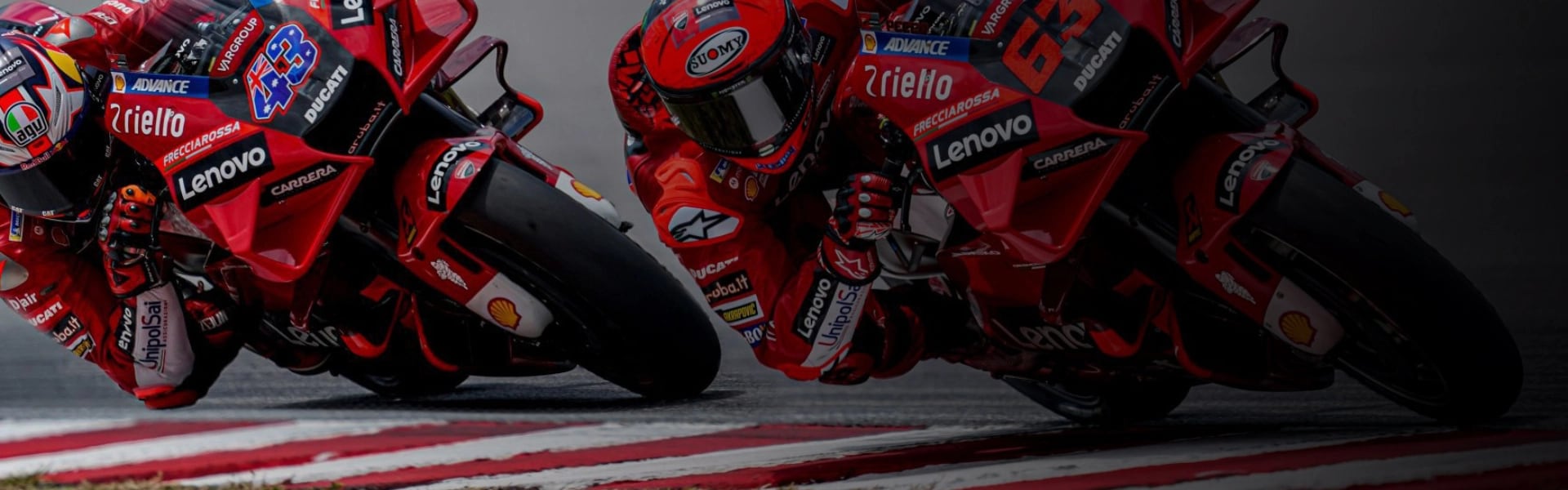 A motorcycle racer talking to his pit crew