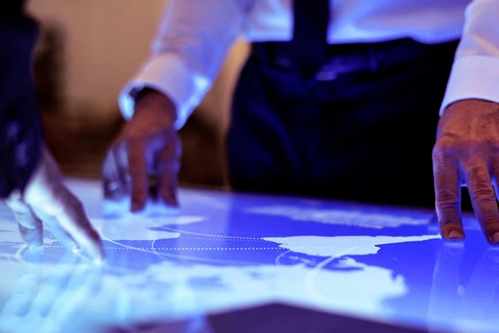 Business man looking over a world map.