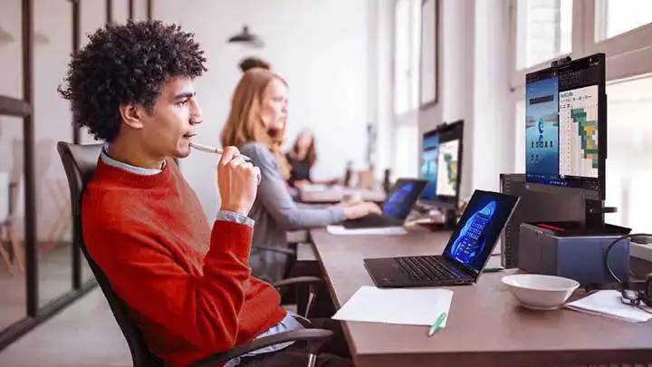 A row of people working at their desks 