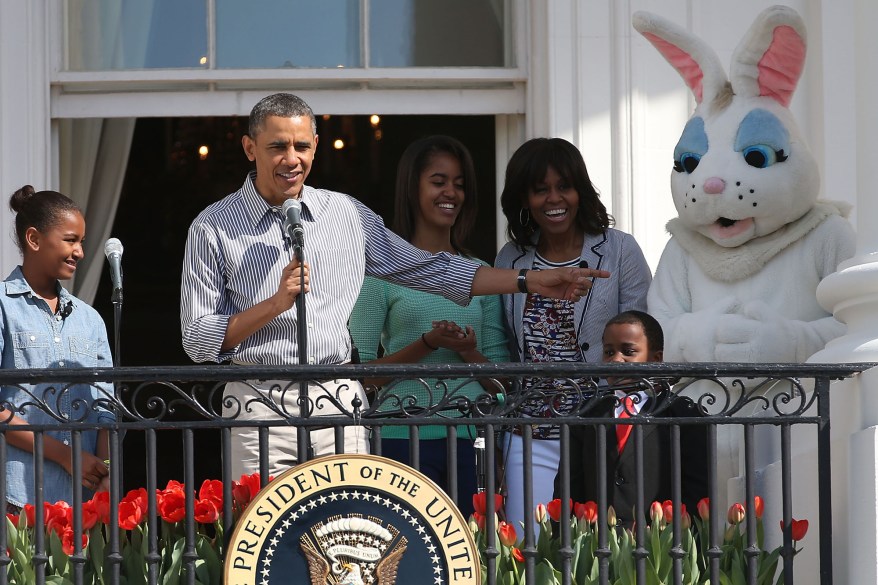 WASHINGTON, DC - APRIL 01: U.S. President Barack Obama speaks while flanked by his daughters Sasha (L), Malia, first lady Michelle Obama, Robby Novak and the Easter Bunny, during the annual Easter Egg Roll on the White House tennis court April 1, 2013 in Washington, DC. Thousands of people are expected to attend the 134-year-old tradition of rolling colored eggs down the White House lawn that was started by President Rutherford B. Hayes in 1878. (Photo by Mark Wilson/Getty Images)