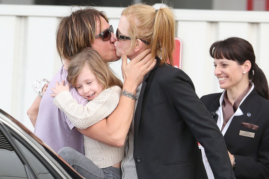 Nicole Kidman gets a welcome kiss from Keith Urban as she lands in Sydney. Pictured: Nicole Kidman, Keith Urban and Sunday Rose Ref: SPL487285 290113 Picture by: Grey Wasp/Blue Wasp/Splash News Splash News and Pictures Los Angeles: 310-821-2666 New York: 212-619-2666 London: 870-934-2666 photodesk@splashnews.com