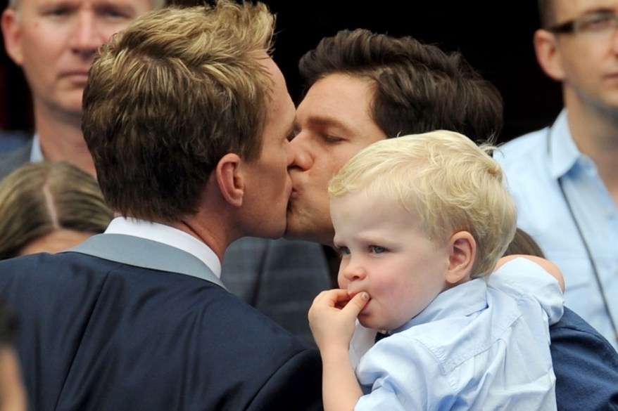 Neil Patrick Harris kisses David Burtka on the lips in LA. Neil was seen arriving for 'The Smurfs 2' premiere in Westwood, Los Angeles and gave both his fiance David and his son a kiss on the lips before hitting the 'blue' carpet at the premiere. Neil plays the lead role in the latest film of the hit franchise 'The Smurfs'! Pictured: Neil Patrick Harris, David Burtka, Gideon and Harper Ref: SPL585508 280713 Picture by: Splash News Splash News and Pictures Los Angeles: 310-821-2666 New York: 212-619-2666 London: 870-934-2666 photodesk@splashnews.com