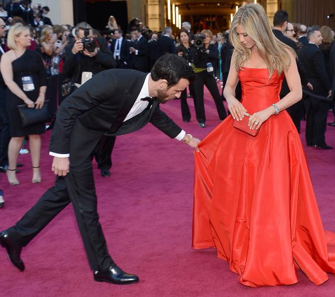 Theroux helps Aniston with her killer gown at the Oscars on Feb. 24, 2013 ...