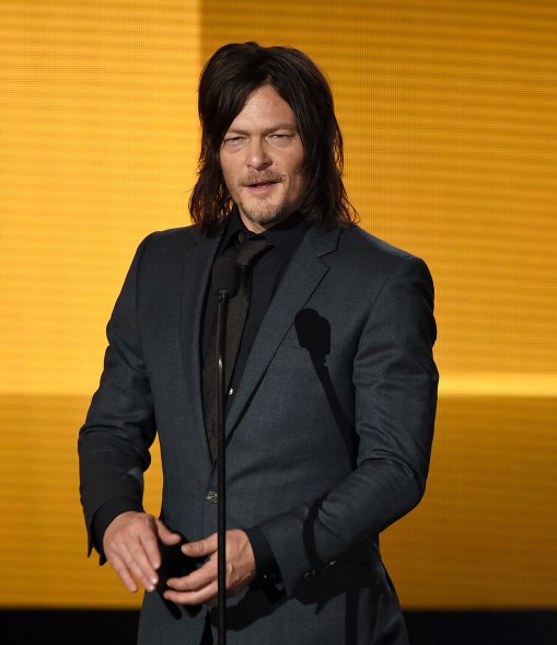 Norman Reedus cleans up his zombie grime to present.