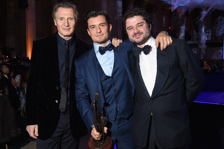 Liam Neeson, honoree Orlando Bloom and Luca Dotti pose for a photo at the UNICEF Snowflake Ball on Tuesday in New York.