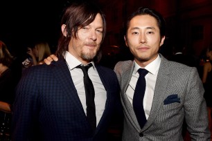 UNIVERSAL CITY, CA - OCTOBER 02: Actors Norman Reedus (L) and Steven Yeun pose at the after party for the premiere screening of AMC Networks' "The Walking Dead" Season 5 at the Universal Studios Backlot on October 2, 2014 in Universal City, California. (Photo by Kevin Winter/Getty Images)