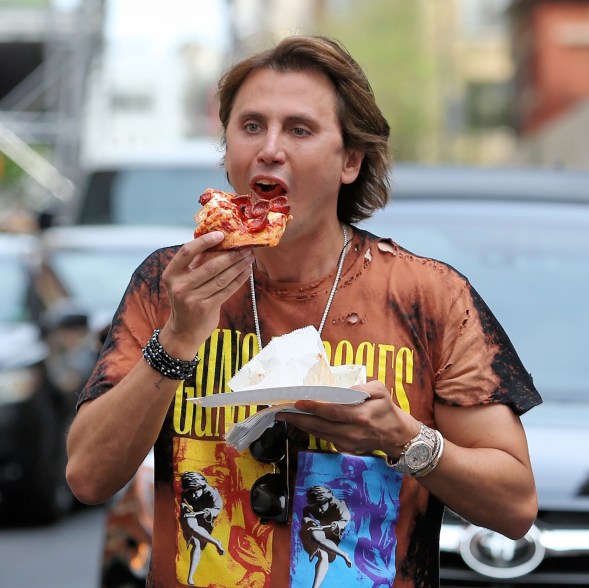 TV personality Jonathan Cheban, aka the Food God, chows down on a pepperoni slice from Prince Street Pizza in Soho in New York City