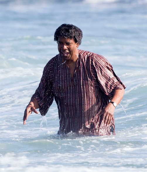 Denzel Washington takes a dip in the Pacific Ocean while filming scenes for ‘Inner City’.