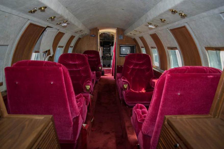 The 1962 red Lockheed JetStarOne, which has been referred to as the 'lost' jet, is expected to fetch over $3.5 million when it is sold at auction on May 27. The aircraft, which is still in its original condition, was one of three jets owned by the legendary singer throughout his life time. This particlauy jet was said to be extra special to Elvis as he owned it with his father Vernon Presley. The jet, which is being listed by GWS Auctions, is currently owned by a private collector who has not been named. The interior was custom designed to Elvis' specifications with gold-tone finishings, woodwork, red velvet seats and a red shag carpet. It also comes with a TV, microwave and a toilet. The jet is one of only 204 aircraft manufactured between 1957 and 1978 in a private project between Jetstar and Lockheed. This aircraft has never been restored and features original external painting and detailing, as well as original interior. The jet is the only airplane once belonging to Elvis that is still owned privately, as the only other two in existence are owned by The Elvis Presley Museum. Pictured: Jet owned by Elvis Presley Ref: SPL1503176 190517 Picture by: Splash News / GWS Auctions Splash News and Pictures Los Angeles: 310-821-2666 New York: 212-619-2666 London: 870-934-2666 photodesk@splashnews.com