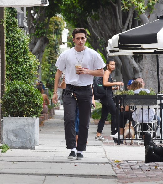 A causally dressed Brooklyn Beckham stops by Cafe Alfred for some iced coffee