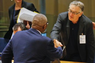 Antigua and Barbuda's Governor General Sir William Rodney, left, and actor Robert De Niro shake hands after they addressed a high-level meeting on Hurricane Irma at the United Nations headquarters, Monday Sept. 18, 2017. (AP Photo/Bebeto Matthews)
