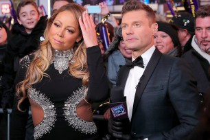 NEW YORK, NY - DECEMBER 31: Mariah Carey and Ryan Seacrest speak during Dick Clark's New Year's Rockin' Eve 2017 at Times Square on December 31, 2016 in New York City. (Photo by Neilson Barnard/DCNYRE2017/Getty Images for dcp)