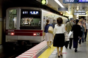 People walk along a subway platform at a station in Tokyo on July 24, 2017. Japan on July 24 held a national exercise to encourage commuters to work from home in a bid to ease traffic congestion as the nation counts down three years to the 2020 Tokyo Olympics. / AFP PHOTO / Toru YAMANAKA (Photo credit should read TORU YAMANAKA/AFP/Getty Images)