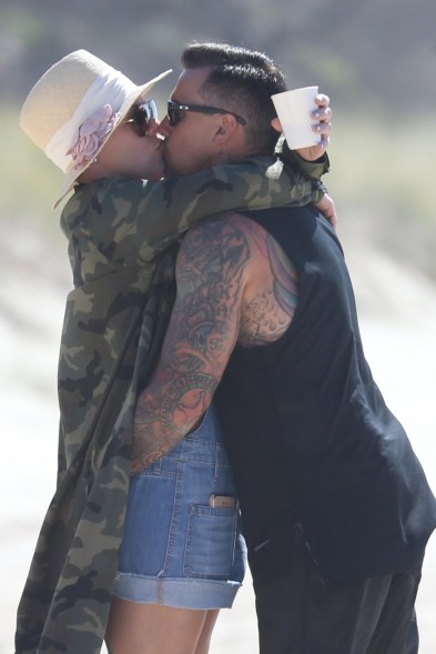 Pink and Carey Hart share a kiss at the beach on the Gold Coast of Australia.