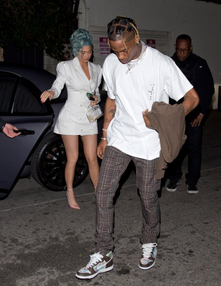 Kylie Jenner and Travis Scott go out to dinner at Craig's in West Hollywood in matching white outfits.