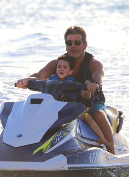 Simon Cowell takes to the sea on a jet ski, with his son, in Barbados.