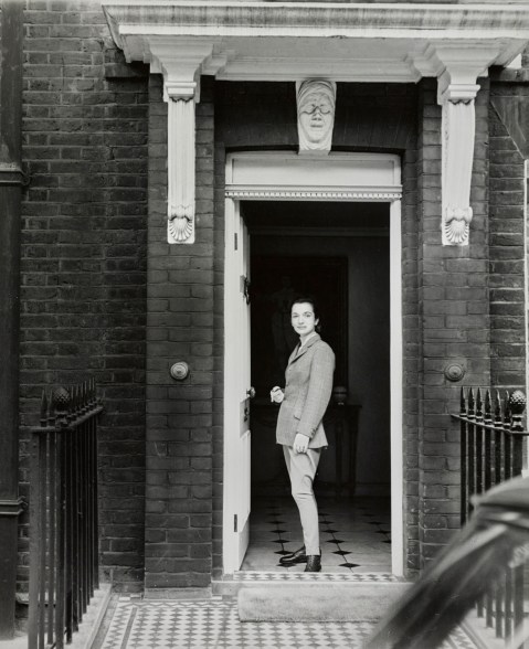 Princess Lee Radziwill (formerly Lee Bouvier), wearing riding habit, leaving her house to ride at Windsor.