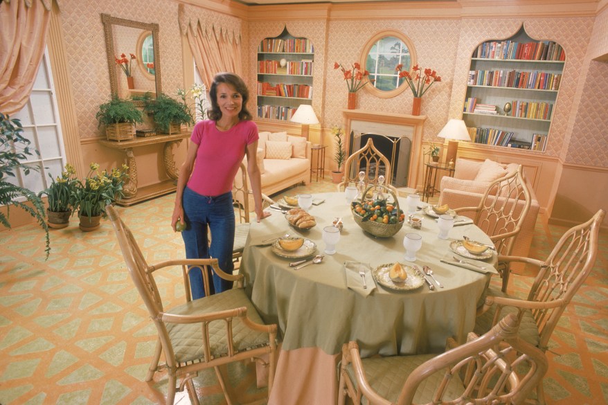 American socialite Lee Radziwill stands and displays her dining room, March 1976.