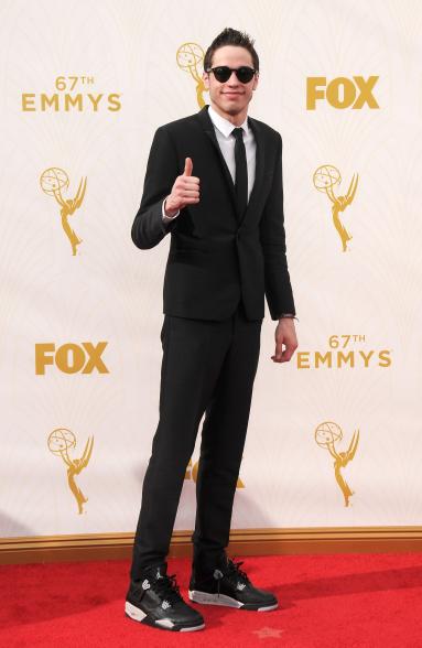 For the 2015 Emmy Awards, Davidson wore another pair of pricey sneakers, but this time dressed them up with a classic skinny black suit and Ray-Ban sunglasses.