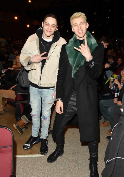 In early 2019, just a few months after his December breakup with Grande, Davidson has been hanging out with pal Machine Gun Kelly. Here, he wears Fendi sneakers, ripped jeans, a splatter-painted hoodie and a workwear-inspired jacket, proving that he hasn't lost his love of high fashion — though he may have toned down his color palettes.